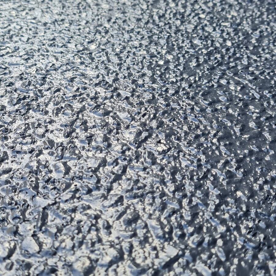 Textured grey anti-slip coating on a concrete surface