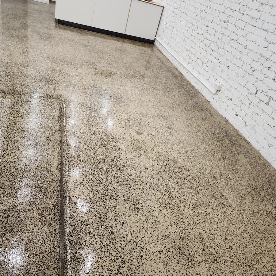 Sealed concrete floor showing a straight saw cut line running through the surface