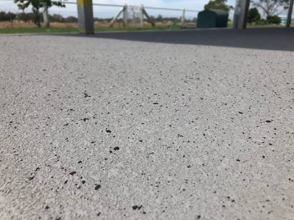 Grey exposed aggregate driveway in front of a double garage