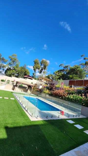 Residential pool with pavers, lawn and stepping pads