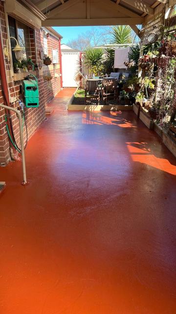 Light coated side path beside a brick wall