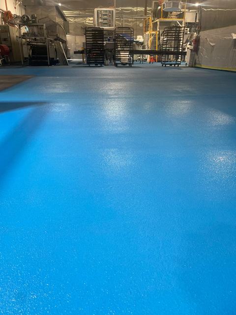 Blue coated warehouse floor with a grey marked zone