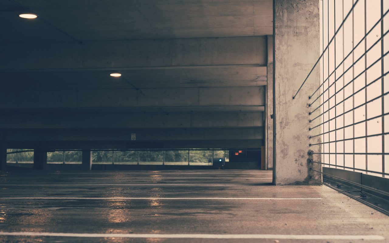 Empty car park floor with wet concrete, shown as a car park floor coating example