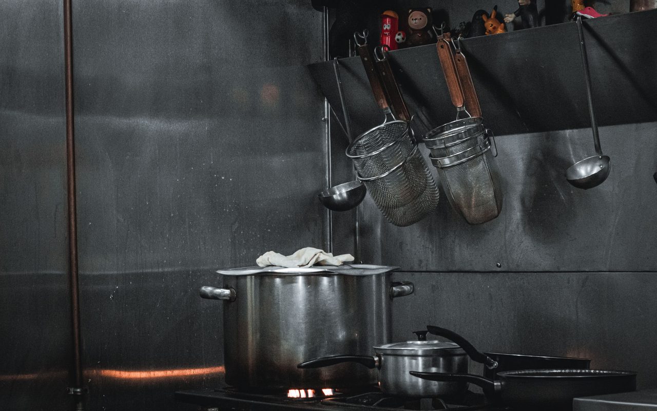 Stainless steel pots on a commercial kitchen stove