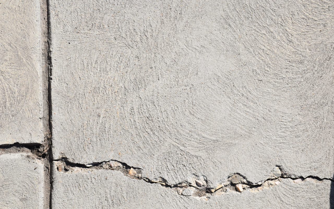 Close-up of a cracked concrete slab at a joint